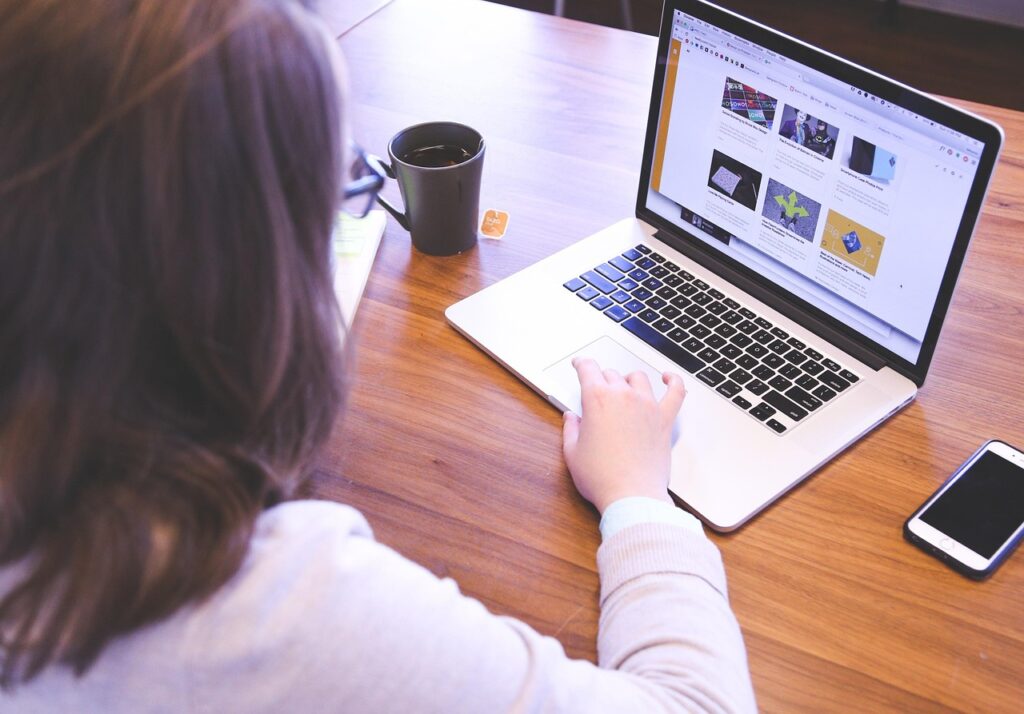 professional person updating resume at desk with coffee focused and confident