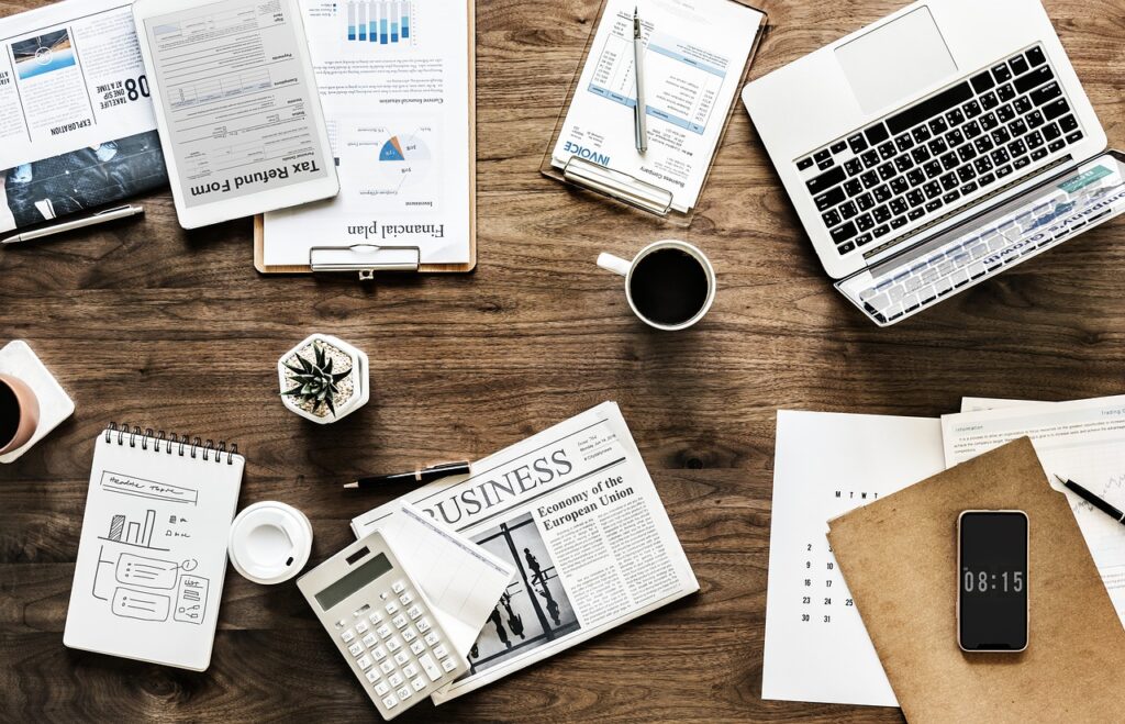 professional person studying at desk with laptop open career planning notebooks